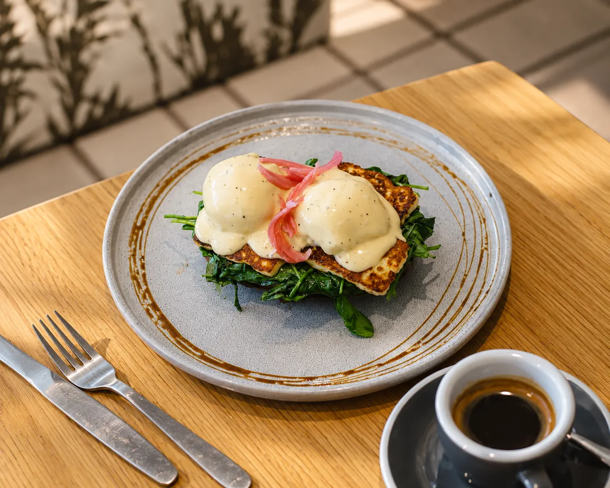 Eggs, greens and coffee on a table at Albion Canteen