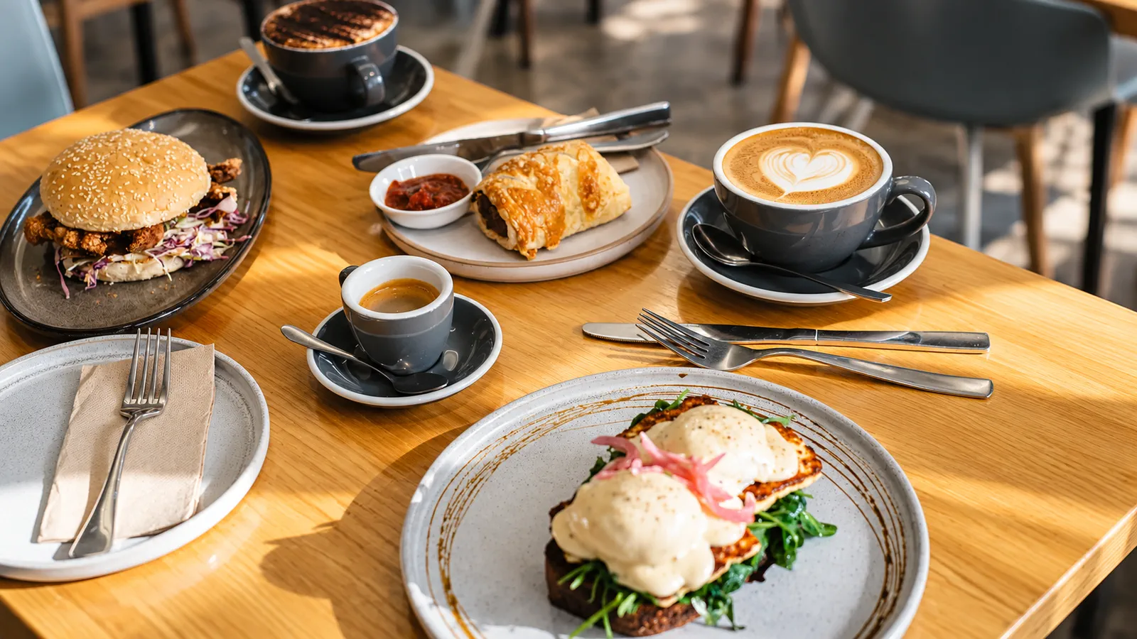 Coffee and breakfast dishes being served across the table