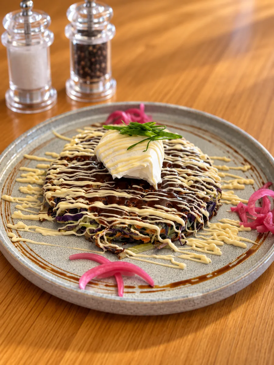 Savoury plated dish with cream and pickled onions