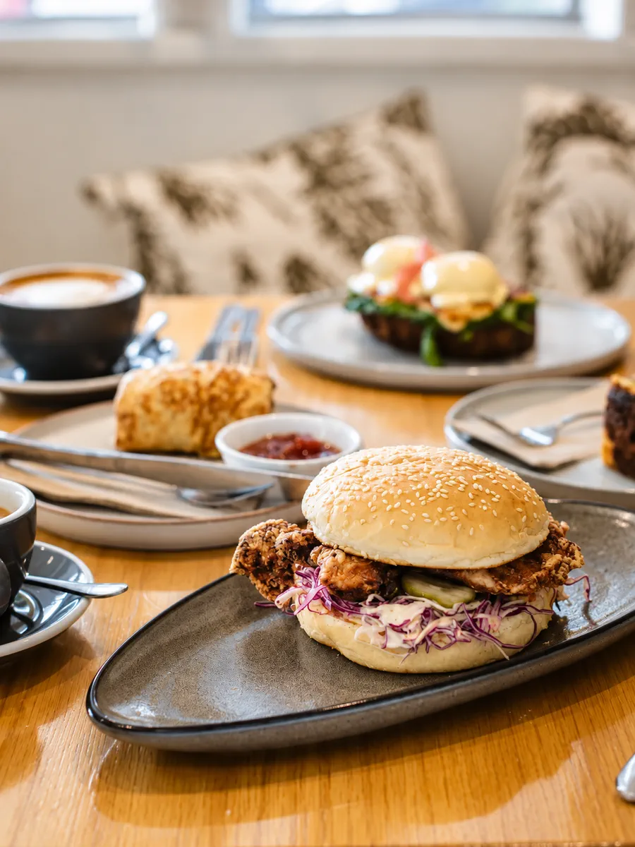 Fried chicken burger and coffee on a dining table